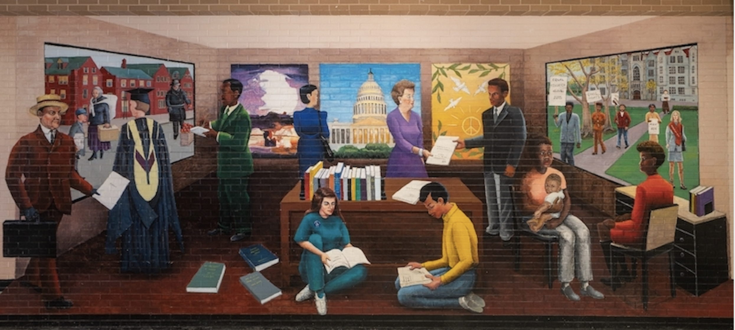 Mural by artist Astrid Fuller from the University of Chicago Office of Civic Engagement. Mural depicts various groups of people reading and talking in a library setting.