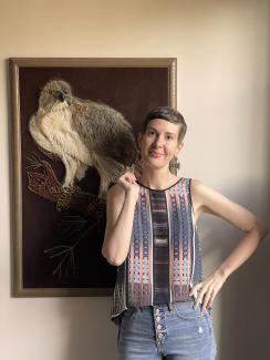 Photo ofpatricia lockwood, white woman, short hair, standing in front of a piece of art
